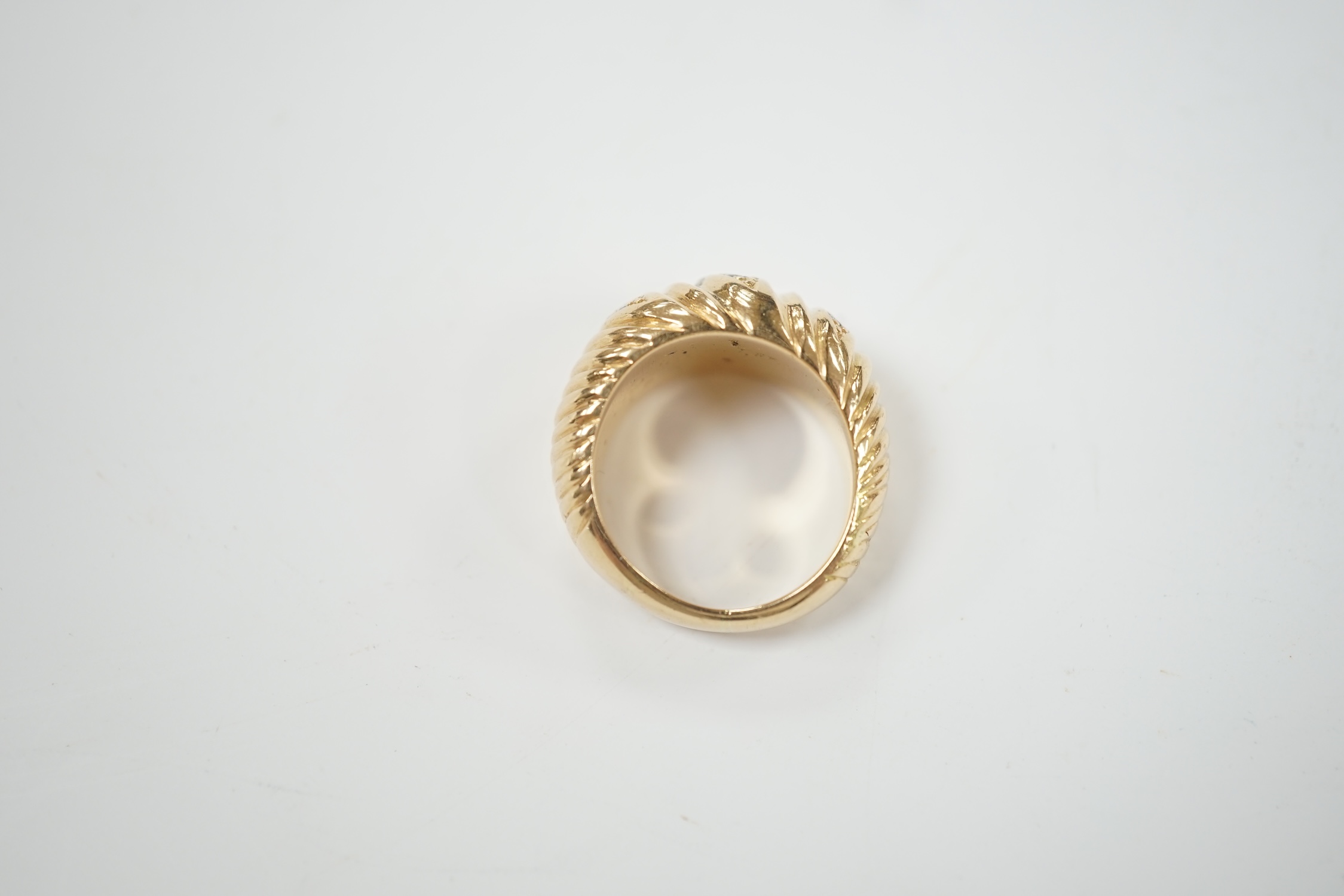 A fluted yellow metal and three row, nine stone diamond set dress ring, size H, gross weight 16 grams.